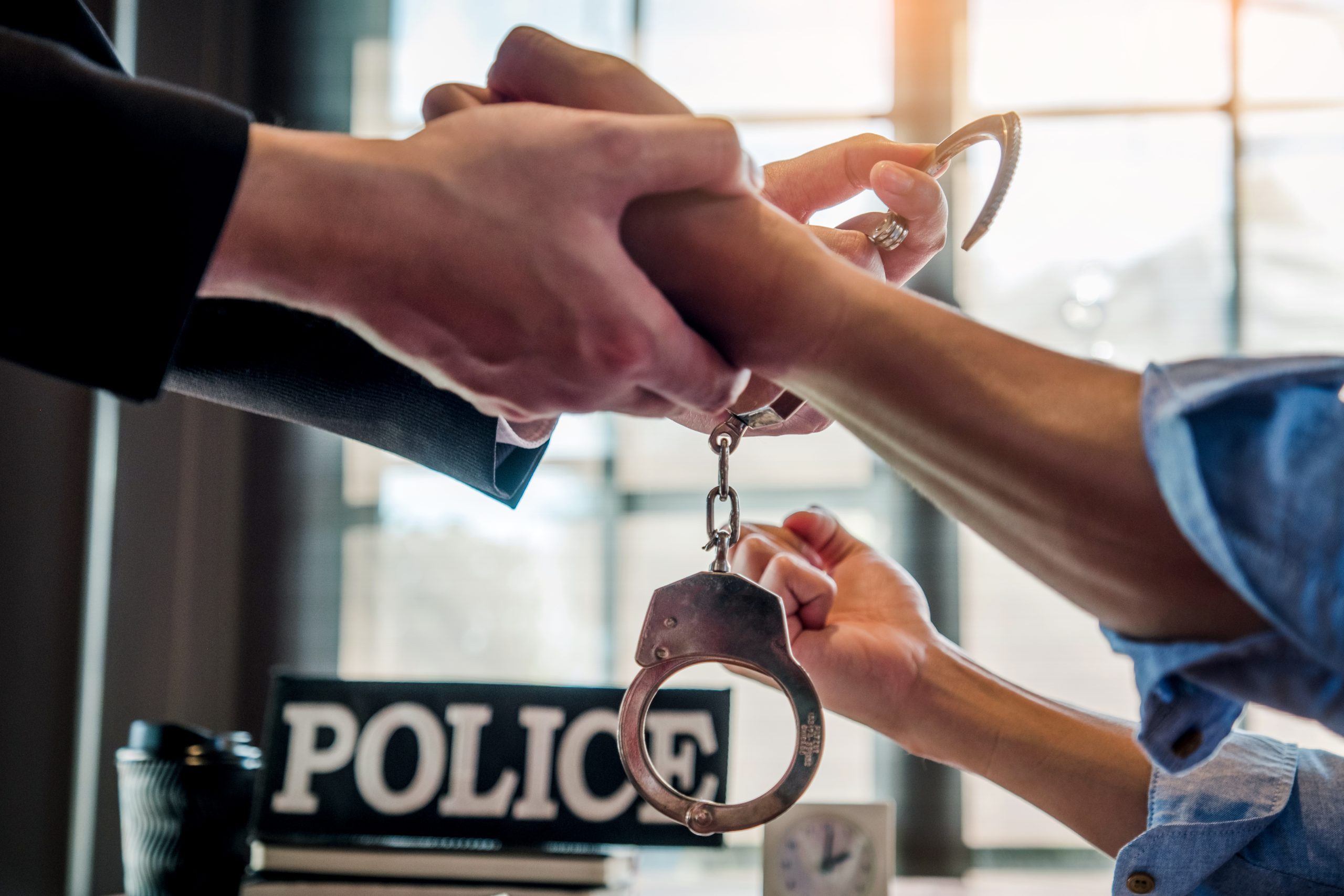 man handcuffing individual