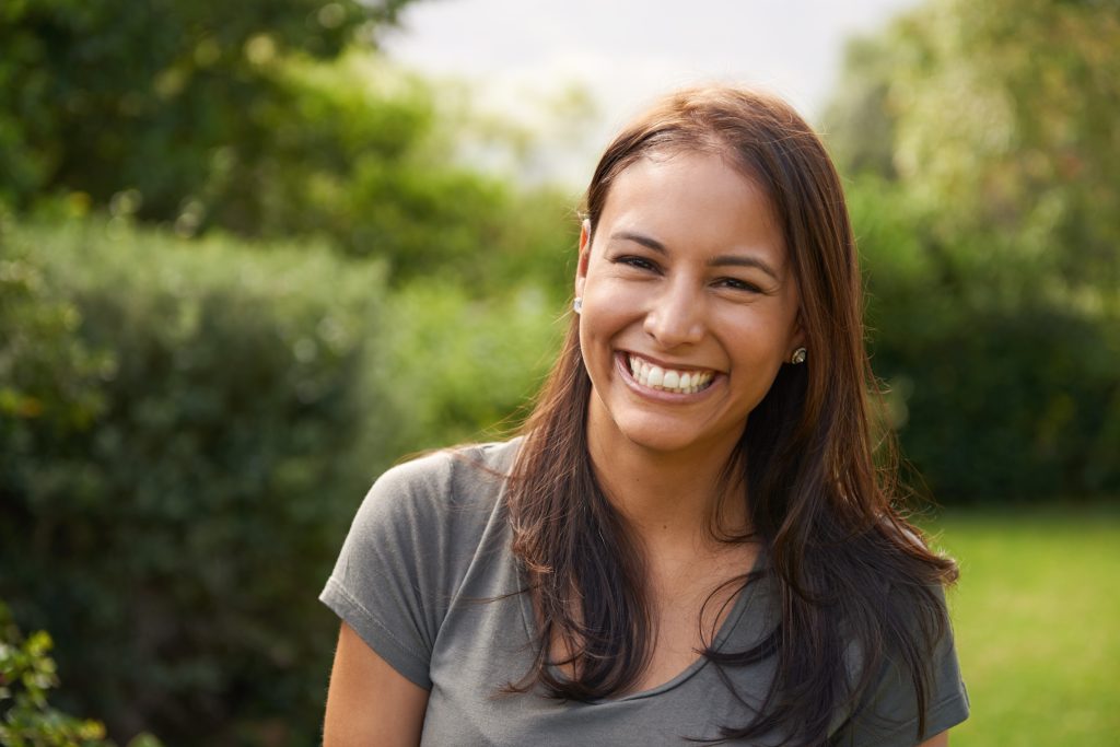 happy hispanic woman outside smiling